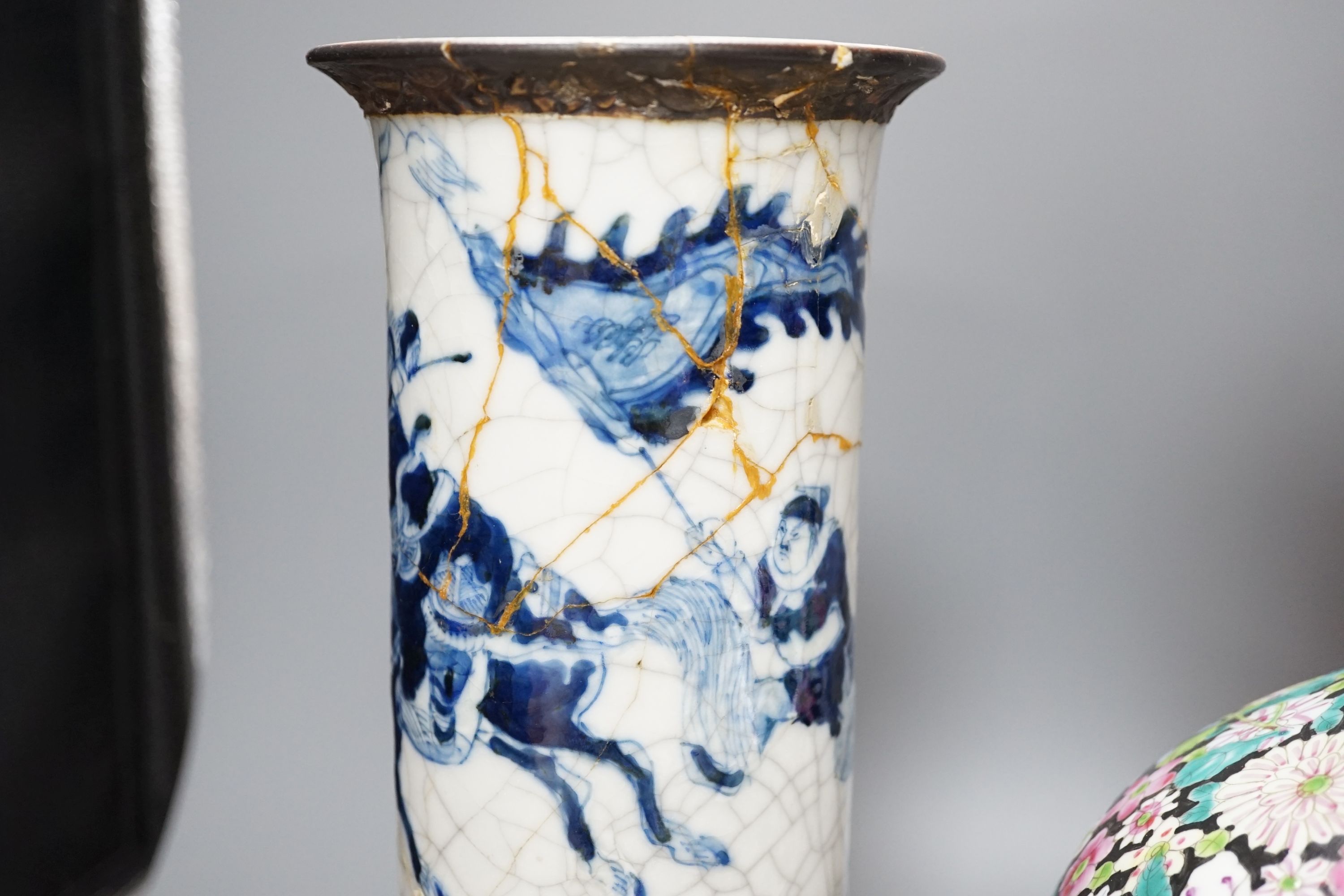 An early 20th century Chinese famille rose thousand flowers bottle vase (restored) together with a Chinese blue and white crackle glazed sleeve vase (a.f)., tallest 40cm